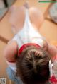 A little girl in a white and red outfit is upside down.