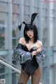 A woman in a bunny costume is posing for a picture.