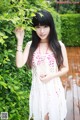 A woman in a white dress posing for a picture.