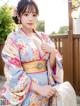 A woman in a kimono posing for a picture.