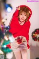 A woman in a red sweater holding a red ball.