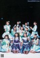 A group of girls in blue and white outfits posing for a picture.